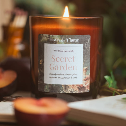 Secret garden vegan candle with plum and books.