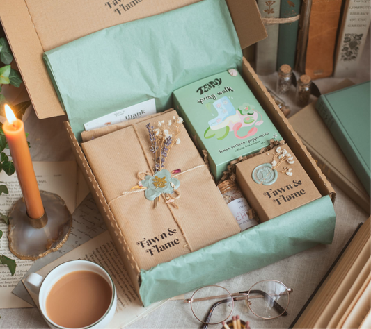 Fawn & Flame seasonal reading ritual subscription box with books, candles, tea and other wellness products.
